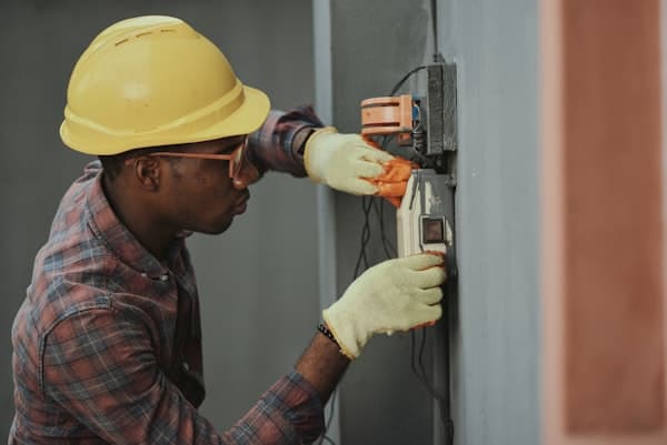 Electrician working on a wall socket — electrical work for The Wetherby Plumber