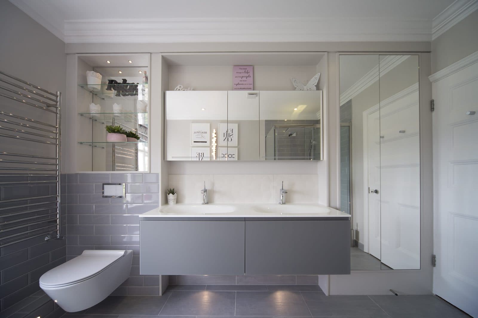Modern bathroom with grey floating vanity and wall-hung toilet installed by The Wetherby Plumber